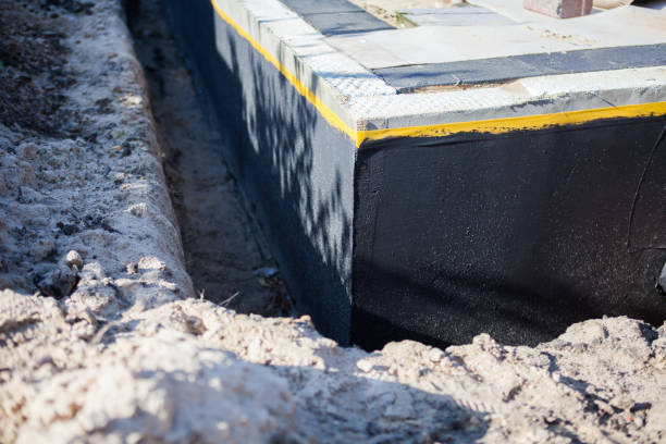 Professional Basement Waterproofing technician working in Sterling, KS